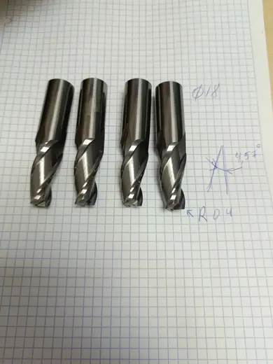 Партия монолитных твердосплавных конусных фрез с рукописными пометками диаметра, угла конусности и радиуса при вершине.